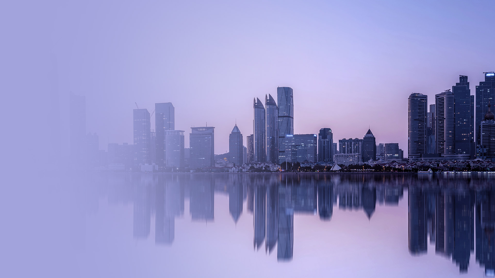 City skyline at dusk reflected in water