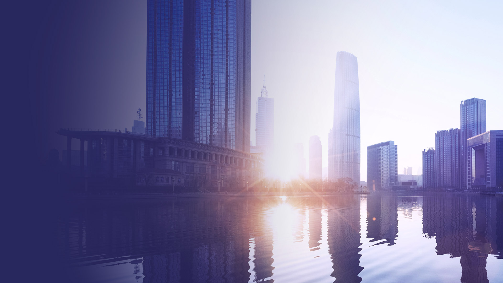 City skyline at sunrise reflected in water